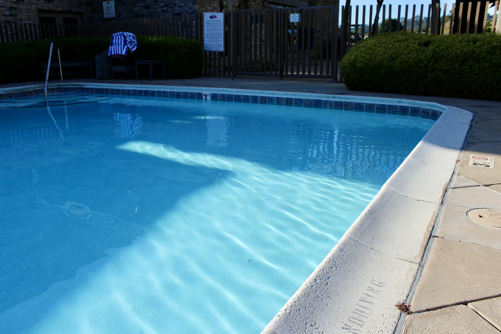 Bright blue pool with sunlit water
